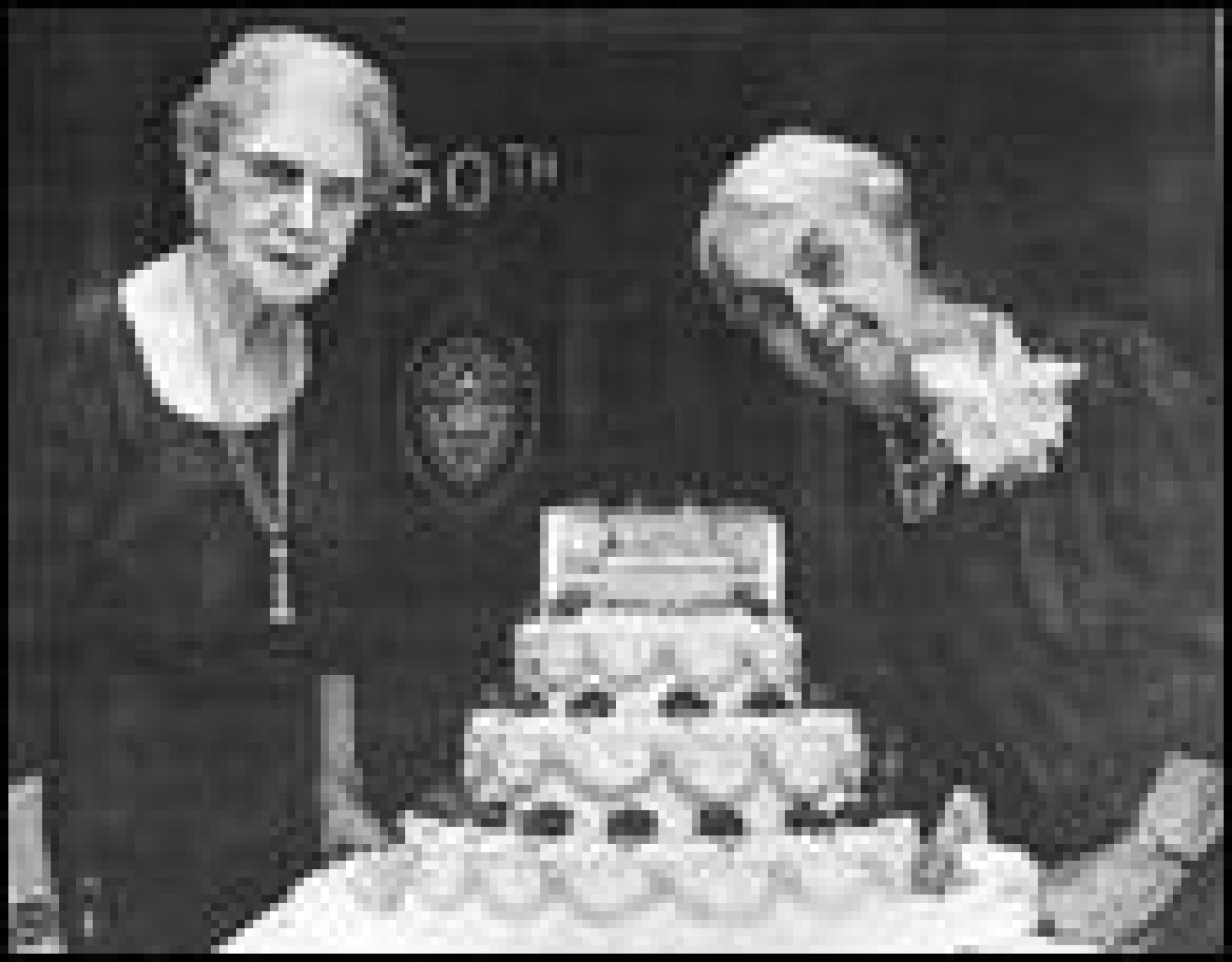 Two women next to the 50th anniversary celebration cake.