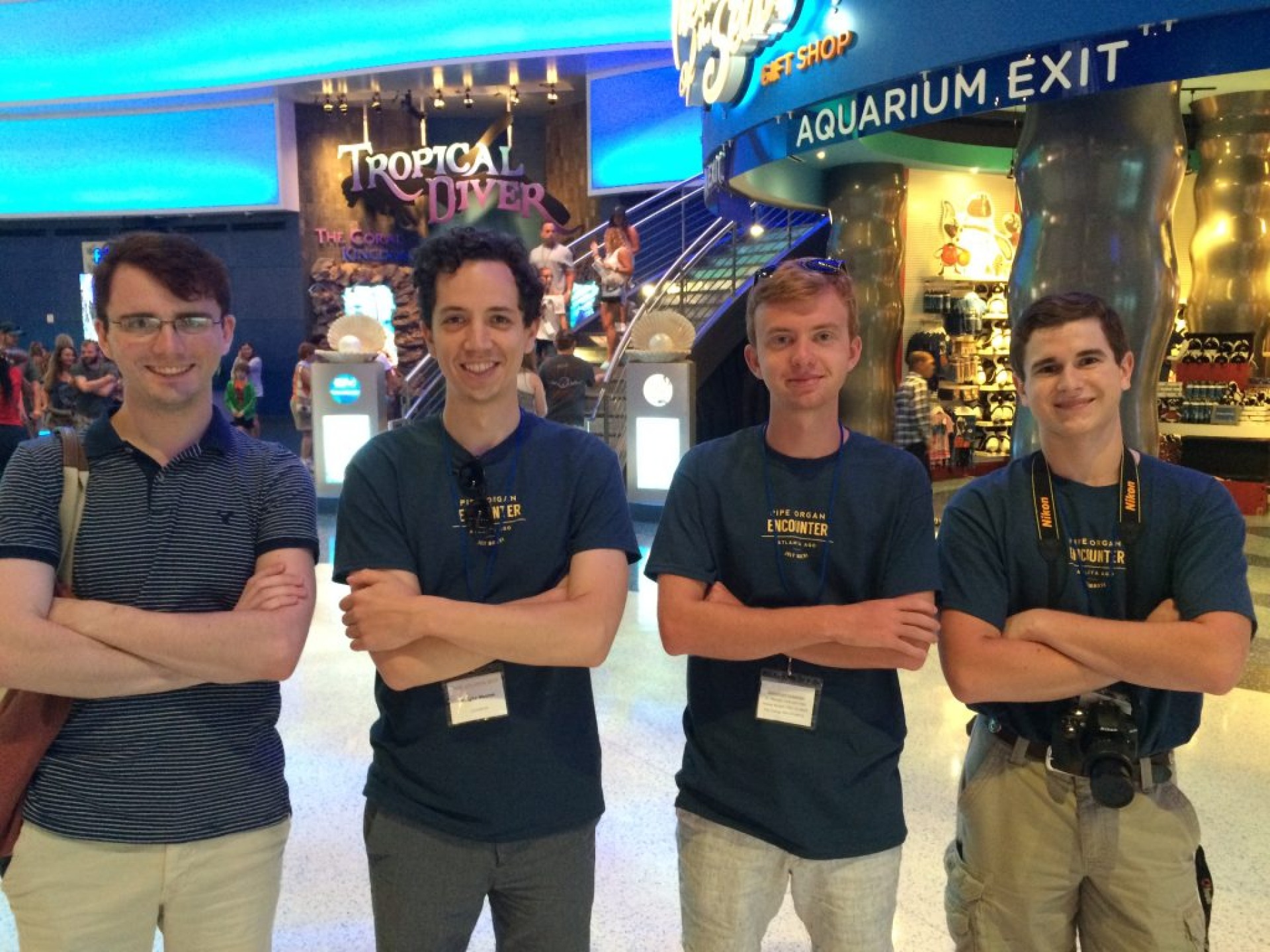 Four Encounter students posing inside of the Georgia Aquarium.