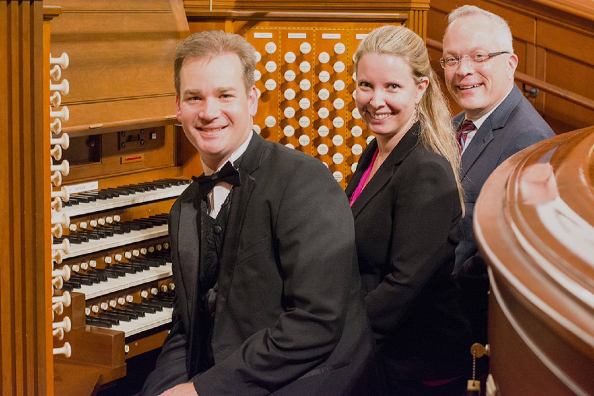 AGO members sitting at an organ.